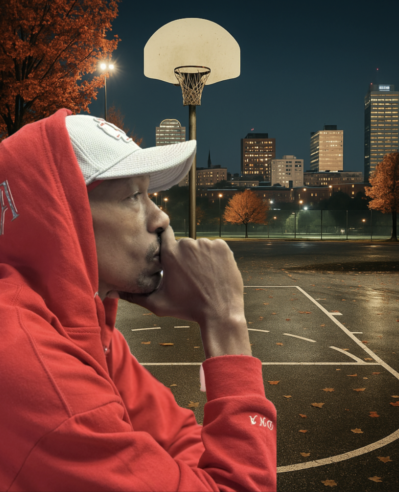 Coach Corey McConnell in a reflective moment on an outdoor basketball court at dusk